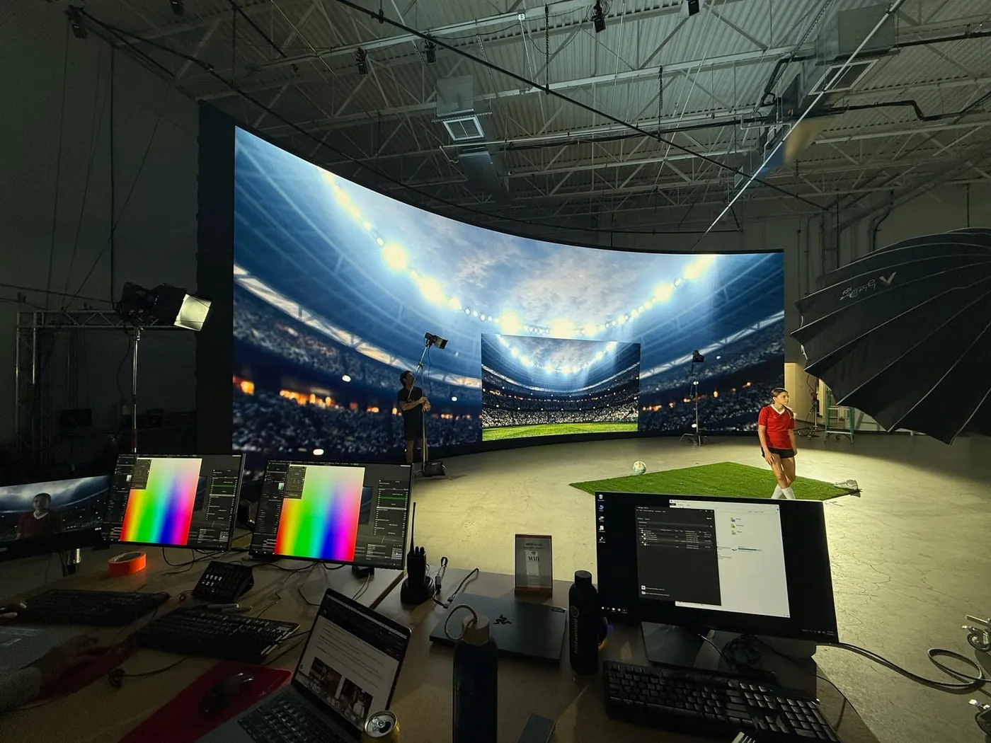 Curved LED volume wall displaying a stadium