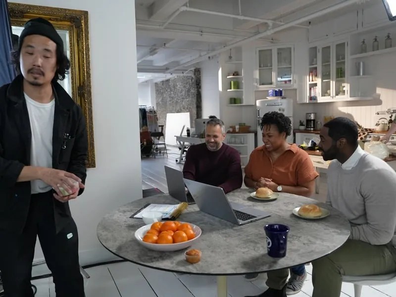 Director working with actors around a kitchen table