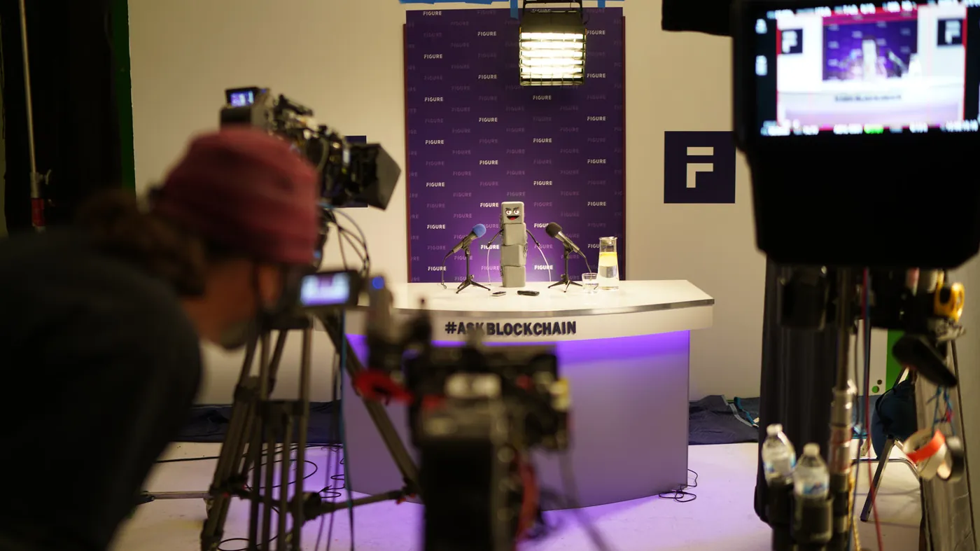 Crew filming a studio interview set