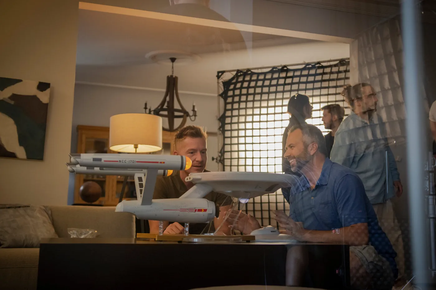 Directing a tabletop shoot with a model starship