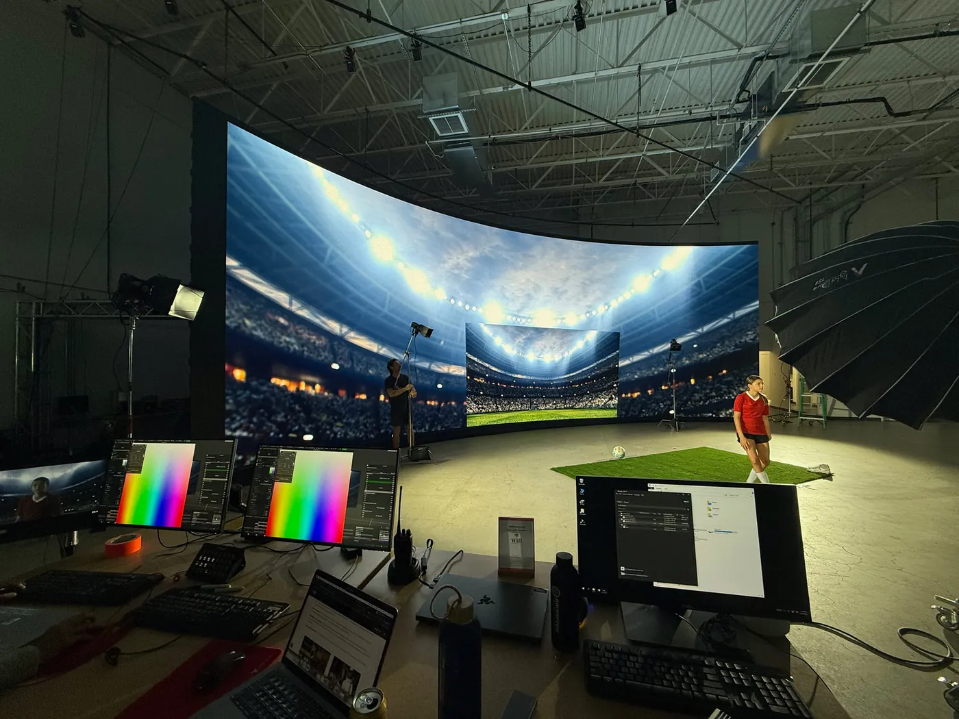 LED volume stage showing a virtual soccer stadium